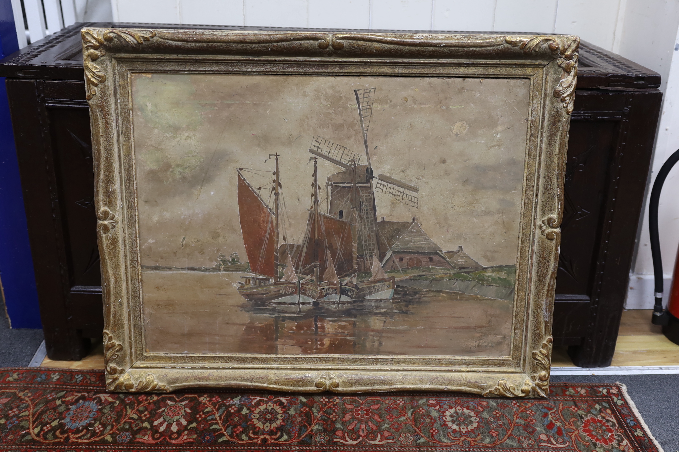 English School c.1900, oil on card, Estuary scene with moored boats and windmill, indistinctly signed, 59 x 78cm